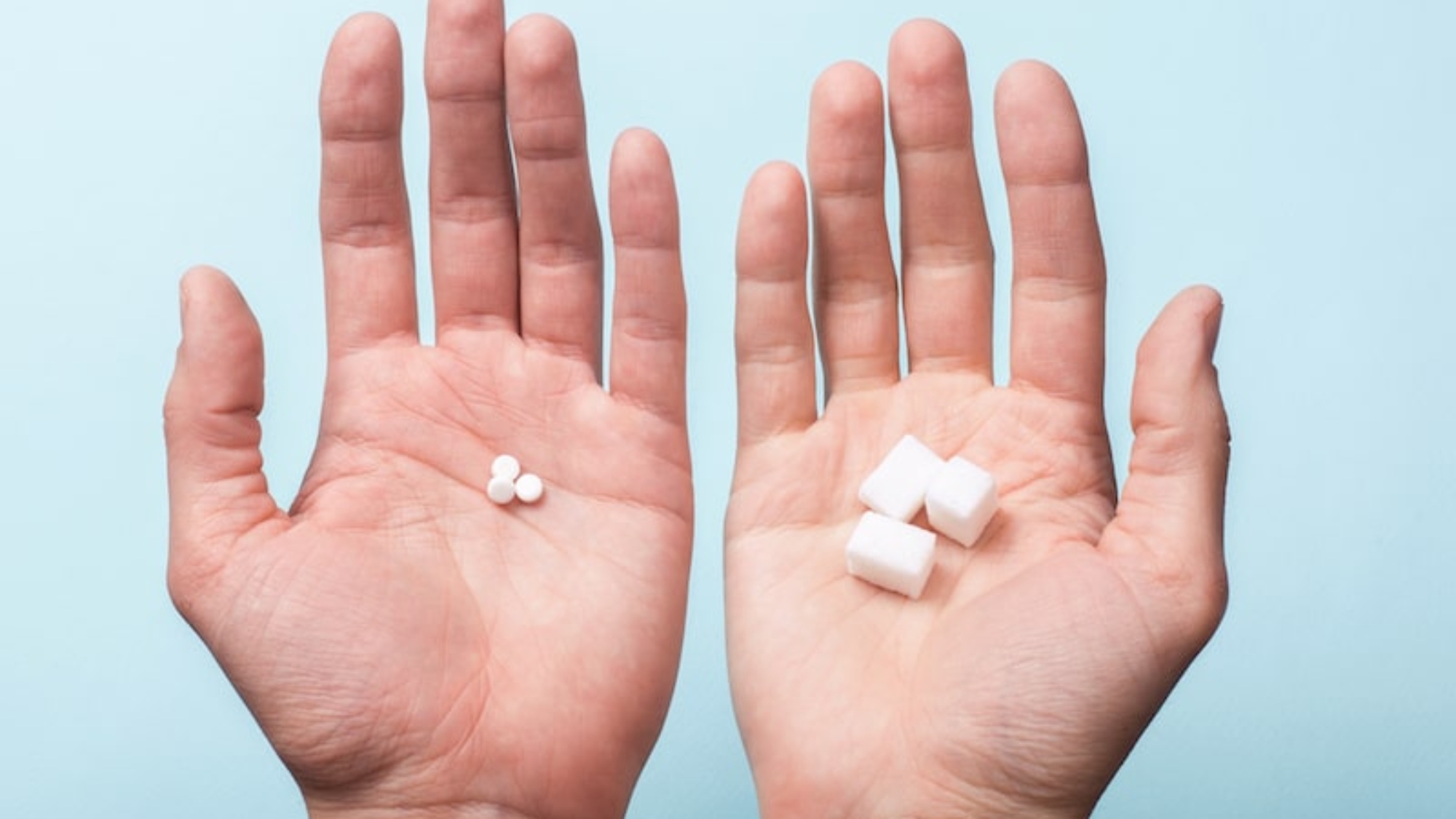 Choice of Sweetener in tablets or regular sugar. Alternative to sugar for diabetics. A man holds sugar in one hand in another sugar sauce in tablets.